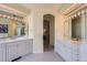 Bright and airy bathroom with double vanities, tile flooring, and ample counter space at 1 Silver Fox Dr, Greenwood Village, CO 80121