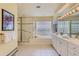 Bright bathroom with a glass enclosed shower, soaking tub, white vanity, and tile flooring at 1 Silver Fox Dr, Greenwood Village, CO 80121