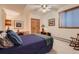 Bedroom featuring carpeted floors, ample closet space, and a large window at 1 Silver Fox Dr, Greenwood Village, CO 80121