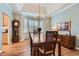 Formal dining room featuring a tray ceiling, chandelier, and hardwood floors at 1 Silver Fox Dr, Greenwood Village, CO 80121