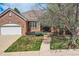 Charming brick home with a well-manicured lawn and a two-car garage at 1 Silver Fox Dr, Greenwood Village, CO 80121