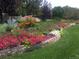 Vibrant flower garden showcasing a diverse array of colorful blooms along a stone retaining wall at 1 Silver Fox Dr, Greenwood Village, CO 80121