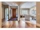 Elegant foyer with hardwood floors, a wooden front door, and an arched entryway to the living room at 1 Silver Fox Dr, Greenwood Village, CO 80121