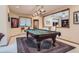 Spacious game room with pool table, carpeted floors, and views to adjacent entertaining areas at 1 Silver Fox Dr, Greenwood Village, CO 80121