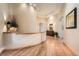 Bright open hallway with hardwood floors, decorative art niche, and wood trim at 1 Silver Fox Dr, Greenwood Village, CO 80121