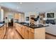 Open-concept kitchen with a center island and seamless flow to the living room and dining area at 1 Silver Fox Dr, Greenwood Village, CO 80121