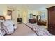 Cozy main bedroom with carpet flooring, a ceiling fan, and a comfortable seating area at 1 Silver Fox Dr, Greenwood Village, CO 80121