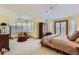 Large main bedroom with neutral carpet, vaulted ceiling, many windows, and a private balcony at 1 Silver Fox Dr, Greenwood Village, CO 80121