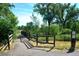 Picturesque walking path featuring a wooden bridge, lush greenery, and signage for the Greenwood Village community at 1 Silver Fox Dr, Greenwood Village, CO 80121