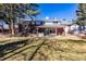 Large backyard with a covered patio, offering an ideal space for outdoor entertaining and relaxation at 13000 Willow Ln, Golden, CO 80401