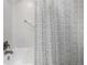 Cozy bathroom features a white tiled tub/shower combo with modern fixtures and decorative shower curtain at 13000 Willow Ln, Golden, CO 80401