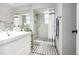 Modern bathroom with a glass-enclosed shower featuring white marble tile and a decorative grey and white rug at 13000 Willow Ln, Golden, CO 80401