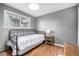 This bedroom features a window with a view and hardwood floors at 13000 Willow Ln, Golden, CO 80401