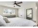 Comfortable bedroom featuring a large window for natural light, soft carpet, and neutral decor for a relaxing space at 13000 Willow Ln, Golden, CO 80401
