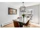 Dining room showcasing a modern chandelier, art, and access to the outdoor patio at 13000 Willow Ln, Golden, CO 80401
