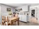 Bright dining area with rustic wood table and chairs, built-in wet bar, and access to the home's interior at 13000 Willow Ln, Golden, CO 80401