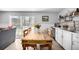 Cozy dining room features a rustic wooden table, light wood floors, and sliding doors to the outdoor patio at 13000 Willow Ln, Golden, CO 80401