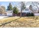 Traditional brick home with a well-manicured lawn, showcasing curb appeal and classic charm at 13000 Willow Ln, Golden, CO 80401