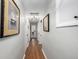 Hallway with hardwood floors and decorative artwork, creates a warm and inviting transition between rooms at 13000 Willow Ln, Golden, CO 80401