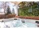 Outdoor hot tub under a covered patio area, perfect for relaxing with its soothing water and setting at 13000 Willow Ln, Golden, CO 80401