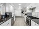 Bright renovated kitchen featuring white cabinets, stainless appliances, and modern countertops at 13000 Willow Ln, Golden, CO 80401