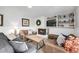 Cozy basement living room with a fireplace, comfortable seating, and built-in shelving at 13000 Willow Ln, Golden, CO 80401