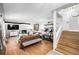 Bright living room features a stone fireplace, large windows, and stylish leather sofas with hardwood flooring at 13000 Willow Ln, Golden, CO 80401