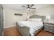 This main bedroom features a ceiling fan, gray wood accent furniture, and light hardwood floors at 13000 Willow Ln, Golden, CO 80401