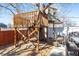Elevated treehouse featuring a wooden deck and stairs, offering a unique and adventurous play area at 13000 Willow Ln, Golden, CO 80401