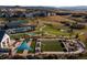 Aerial view showcases lush community lawns, walking paths, pool, tennis, and recreational facilities at 332 Agoseris Way, Castle Rock, CO 80104