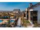 Resort style community pool with well manicured landscape, umbrellas, and an outdoor patio area at 332 Agoseris Way, Castle Rock, CO 80104