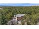 Aerial view of a home surrounded by lush trees, with a private backyard and ample space at 19595 E Top O The Moor Dr, Monument, CO 80132