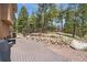 Large backyard deck featuring ample space, landscaping with stone terracing and seating arrangements at 19595 E Top O The Moor Dr, Monument, CO 80132
