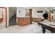 Entertaining basement featuring a bar area, pool table, stairs, and living space at 19595 E Top O The Moor Dr, Monument, CO 80132