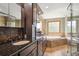 Beautiful bathroom featuring tile flooring, large vanity with granite countertop, soaking tub and walk in shower at 19595 E Top O The Moor Dr, Monument, CO 80132