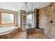 Bathroom with tile flooring, soaking tub and walk in shower with glass door at 19595 E Top O The Moor Dr, Monument, CO 80132