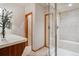 Bathroom with a glass-enclosed shower, tile walls, and ample counter space at 19595 E Top O The Moor Dr, Monument, CO 80132