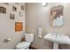 Charming powder room with an antique sink and toilet with vintage decorations at 19595 E Top O The Moor Dr, Monument, CO 80132