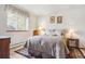 Cozy bedroom featuring a large window, soft lighting, and a comfortable bed at 19595 E Top O The Moor Dr, Monument, CO 80132