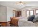 Cozy bedroom features hardwood floors, vaulted ceiling, and a seating area next to large windows at 19595 E Top O The Moor Dr, Monument, CO 80132