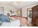 Comfortable bedroom with warm color accents, hardwood floors, and a connected bathroom at 19595 E Top O The Moor Dr, Monument, CO 80132