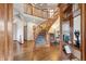 Spacious foyer with a winding staircase, hardwood flooring, and views of the second-floor balcony at 19595 E Top O The Moor Dr, Monument, CO 80132