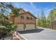 Attached two-car garage with an asphalt driveway at 19595 E Top O The Moor Dr, Monument, CO 80132
