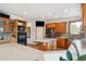 Well-equipped kitchen with wood cabinets, stainless steel appliances, and a breakfast bar at 19595 E Top O The Moor Dr, Monument, CO 80132