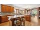Spacious kitchen features wood cabinets, countertops, and a view to the adjacent breakfast and Gathering room at 19595 E Top O The Moor Dr, Monument, CO 80132