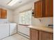 Functional laundry room with washer, dryer, and ample cabinet space for storage at 19595 E Top O The Moor Dr, Monument, CO 80132