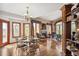 Spacious living room featuring hardwood floors, fireplace, built-in bookshelves and large picture windows offering views at 19595 E Top O The Moor Dr, Monument, CO 80132