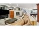 Spacious living room with a fireplace, wet bar, and ample seating featuring a large TV at 19595 E Top O The Moor Dr, Monument, CO 80132