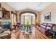 Bright living room with hardwood floors, a fireplace, and large windows offering scenic views at 19595 E Top O The Moor Dr, Monument, CO 80132