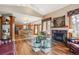 Open-concept living space with hardwood floors, a fireplace, and views of the kitchen and dining areas at 19595 E Top O The Moor Dr, Monument, CO 80132